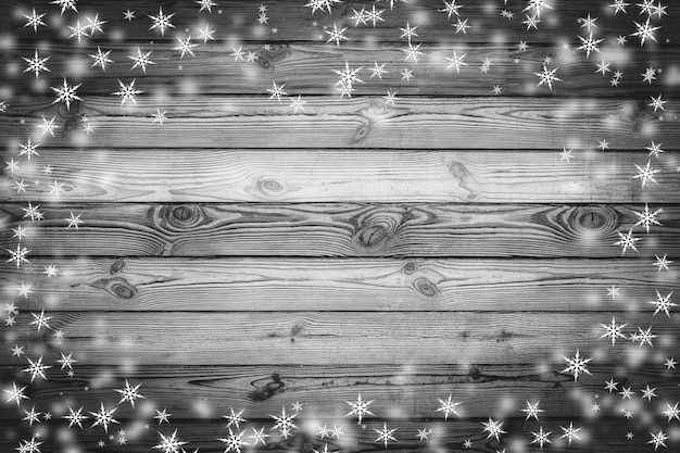 Brown wood wall texture with white snow and stars Christmas background