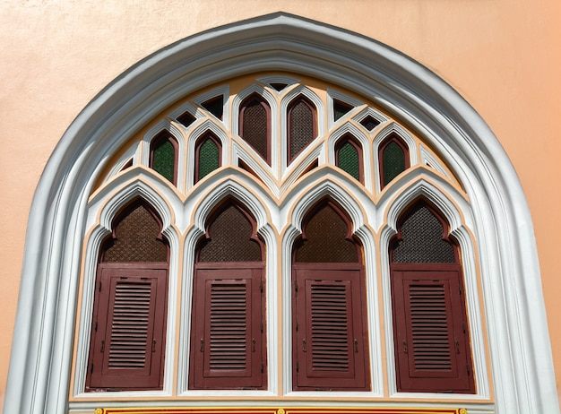 Brown wood window at classic pale orange building