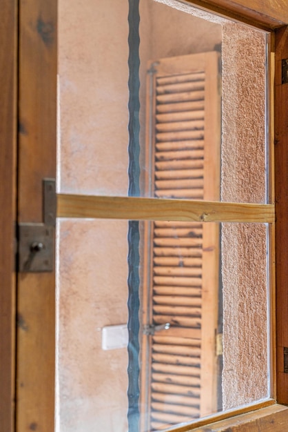 Brown wooden window in a bathroom of a rustic house in Majorca