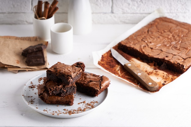 Brownie chocolate cake served on white table