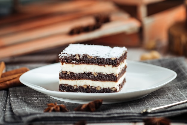 Brownie dessert with chocolate cakes with nuts on the white wooden