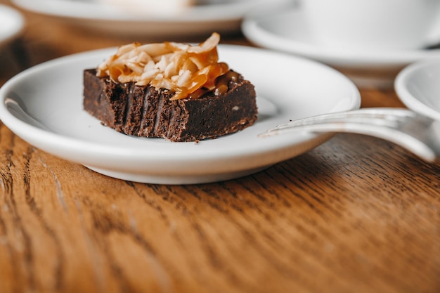 Brownie with almonds on a wooden table.