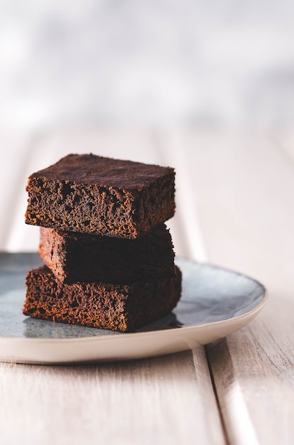 Brownies stacked on a light blue dish