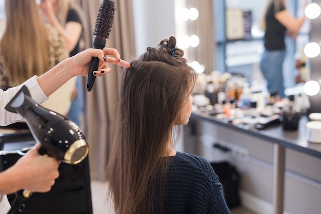 Brunette girl getting her hair done