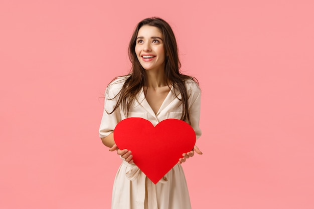 brunette girl holding red heart