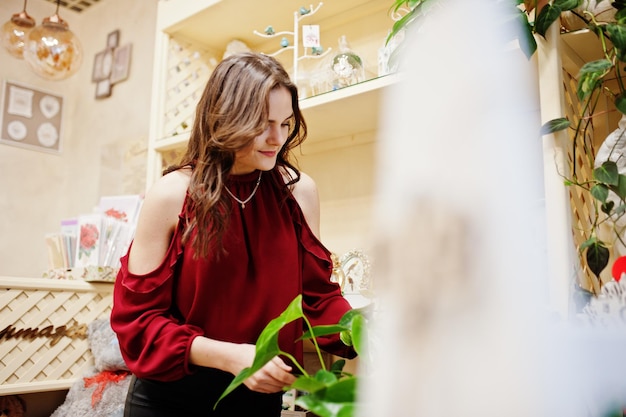 Brunette girl in red buy flowers at flower store