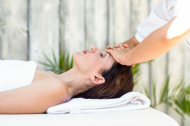 Brunette receiving forehead massage