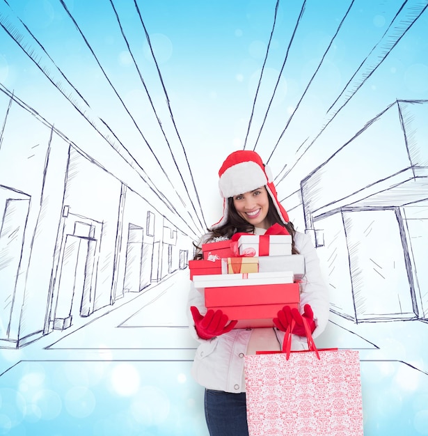 Brunette in winter clothes holding many gifts and shopping bags against blue abstract light spot design