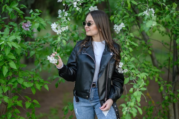 Brunette with long hair In the apple bushes in spring