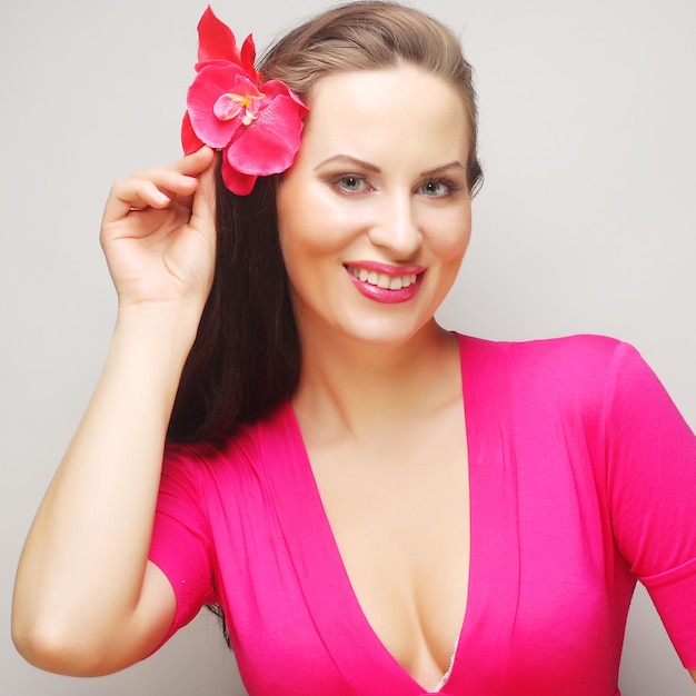 Brunette with long hair in pink wear happy smiling