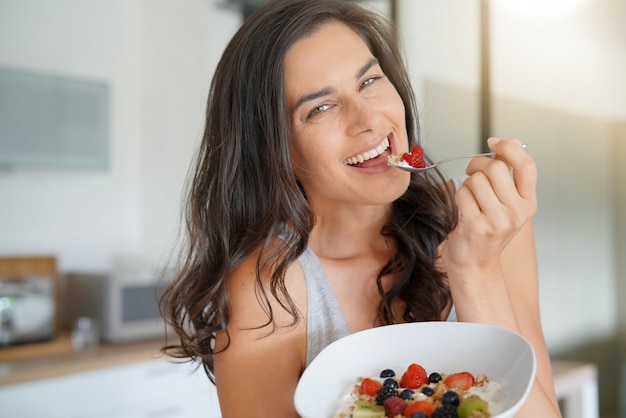 Brunette woman having healthy breakfast at home