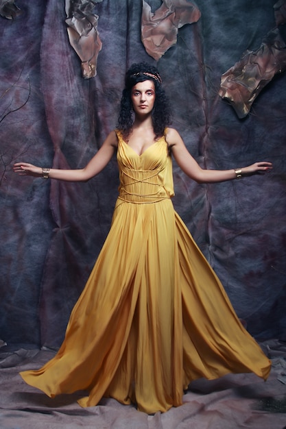 Brunette woman wearing yellow evening dress