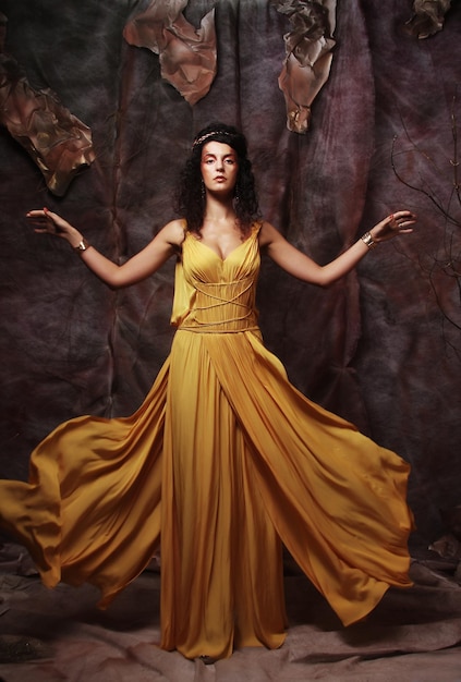 Brunette woman wearing yellow evening dress