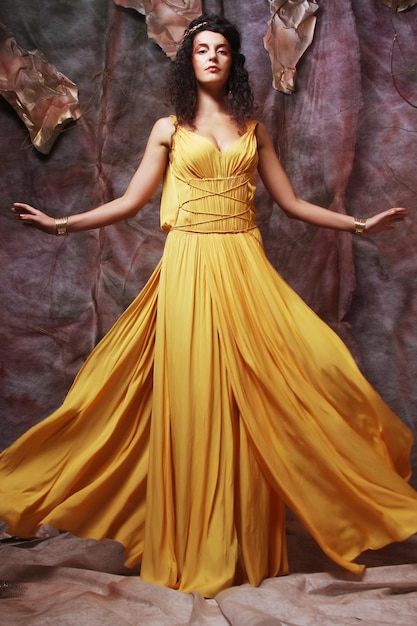 Brunette woman wearing yellow evening dress