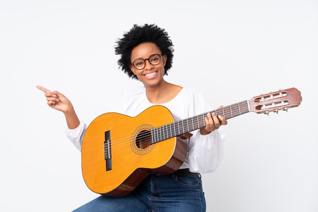 Brunette woman with a guitar over white background