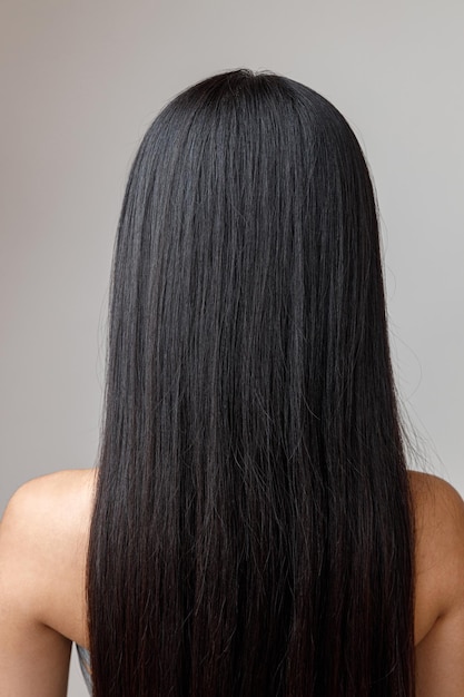 Brunette young woman with long hair standing in studio