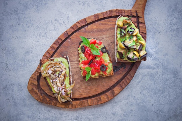 Bruschetta on a dark back, Assorted bruschetta, Top view