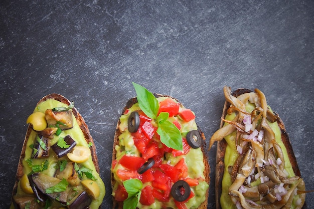 Bruschetta on a dark back, Assorted bruschetta, Top view