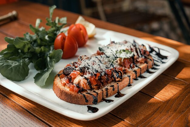 Bruschetta. Italian bruschetta with tomatoes, mozzarella cheese and herbs on a plate