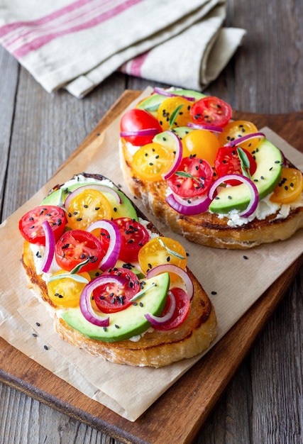 Bruschetta with avocado tomatoes onions and white cheese Vegetarian food Sandwich Italian food