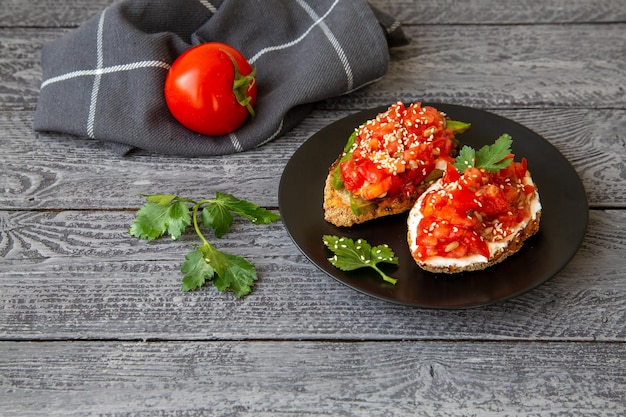 Bruschetta with cottage cheese avocado tomatoes greens white sesame seeds Healthy food rich in healthy fats fiber vitamins antioxidants Vegetarian food