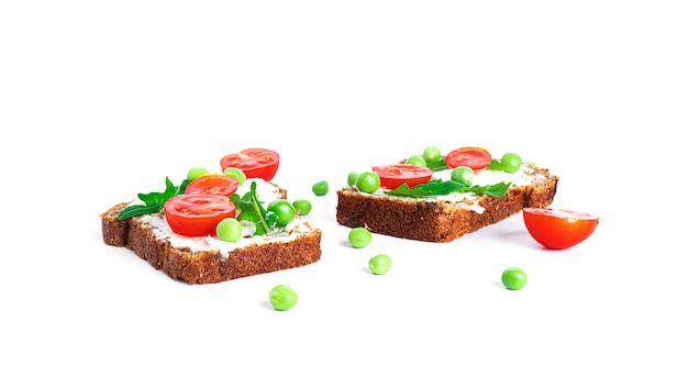 Bruschetta with cream cheese and vegetables isolated on a white background. Toasts isolated. Sandwich isolated. Sandwich with vegetables and cheese. High quality photo