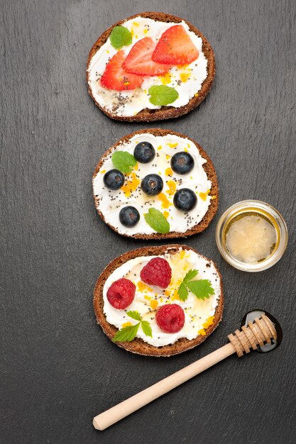 Bruschetta with fresh berries goat cheese honey and chia seeds top view