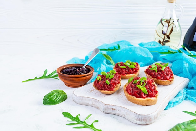 Bruschetta with grated beetroot herbs and caramelized onion