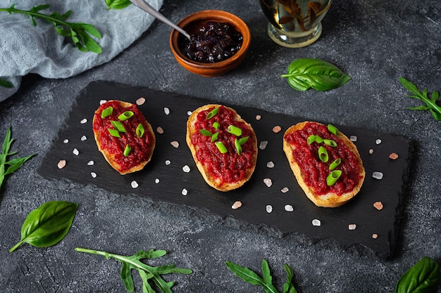 Bruschetta with grated beetroot herbs and caramelized onion