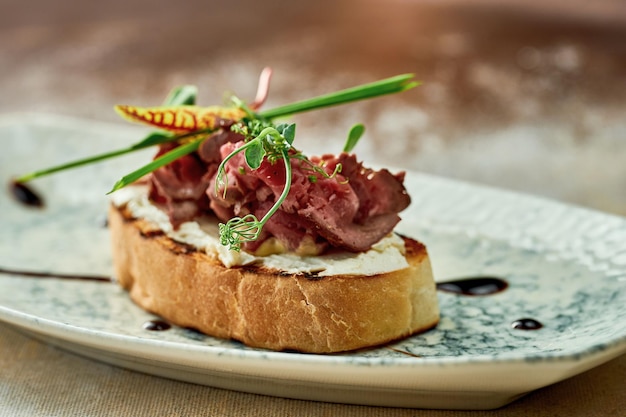 Bruschetta with roast beef in a plate. Close-up, selective focus