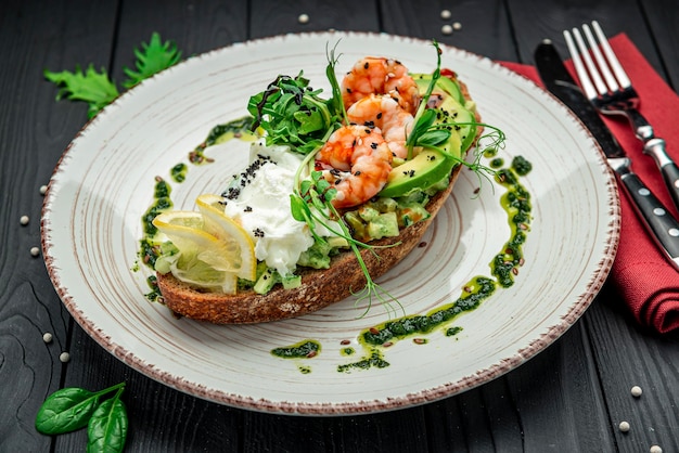 Bruschetta with shrimp guacamole cream cheese and pesto sauce