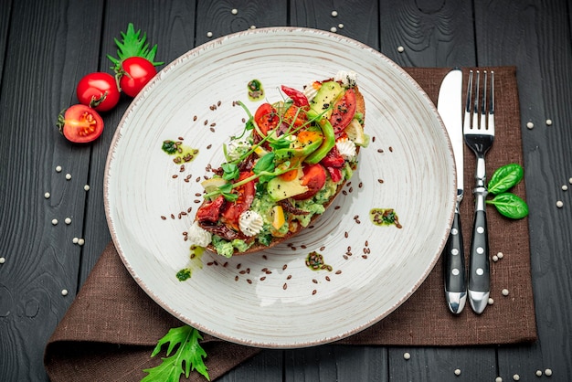 Bruschetta with sundried tomatoes cream cheese avocado and fresh vegetables