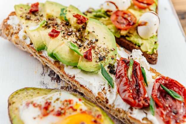 Bruschettas with avocado and avocado with egg healthy breakfast