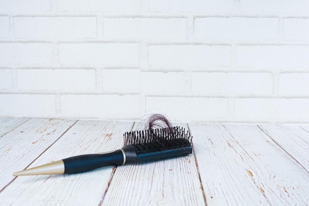 A brush with lost hair on table