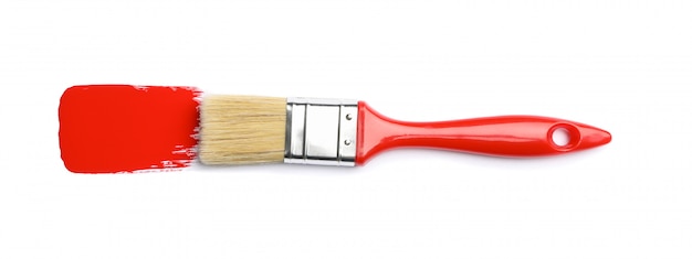 Brush with red paint isolated on white surface