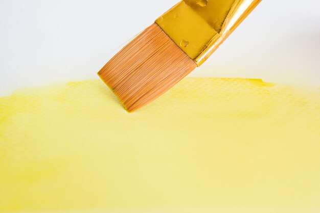 Brush with yellow paint watercolor