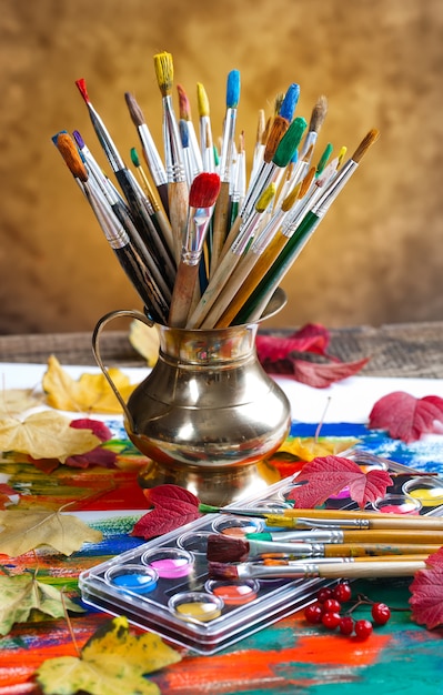 Brushes and paints for drawing in composition on the table