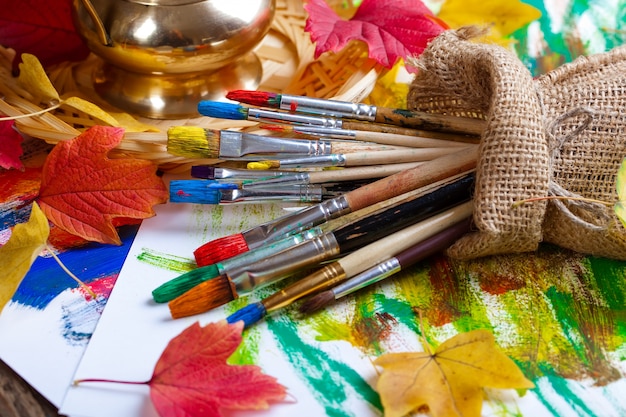 Brushes and paints for drawing in composition on the table