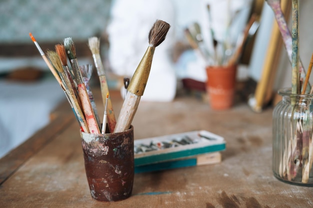 The brushes and paints on table in art studio