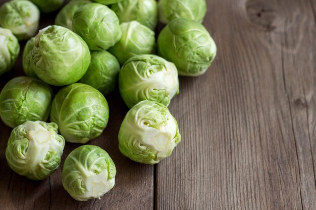 Brussels sprouts on wooden table close up with copy space