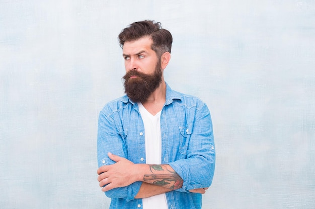 Brutal caucasian hipster with mustache Mature hipster with beard barber care emit confidence barbershop master Bearded man seriously tuned Male casual fashion style Denim look in bad mood