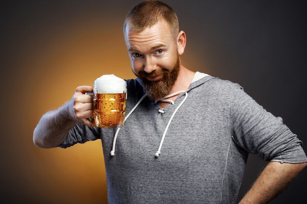 brutal man with a glass of beer