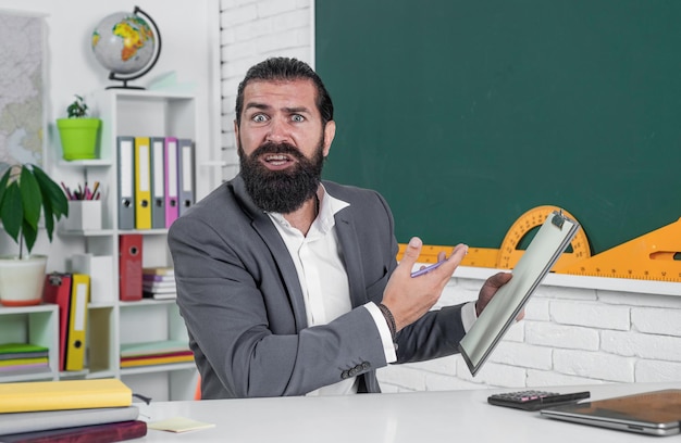 brutal unshaven guy university lecturer in classroom school