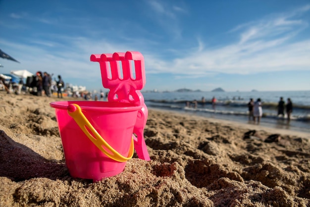 Bucket and scoop in the sand on the beach on vacation