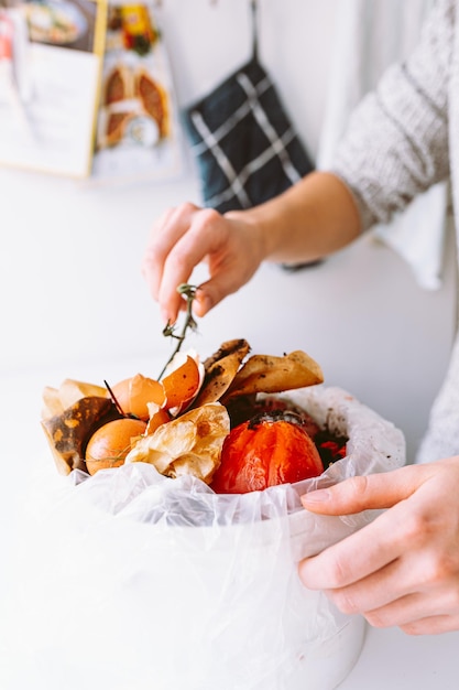 Bucket with biological garbage, food waste in biodegradable package