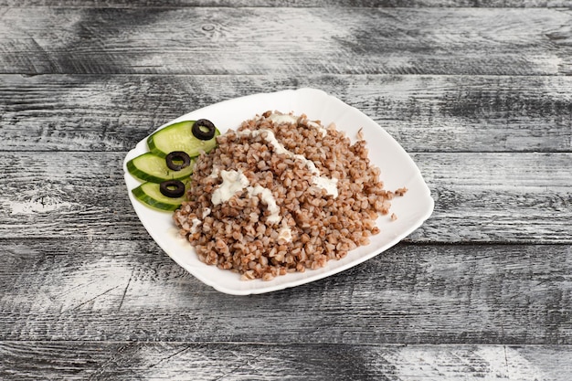 Buckwheat boiled buckwheat on a wooden white background