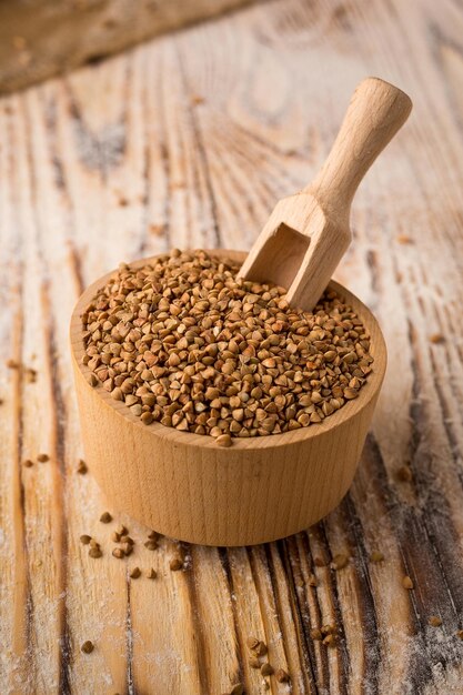 Buckwheat groats in bowl on a wooden background Healthy dietary cereals concept