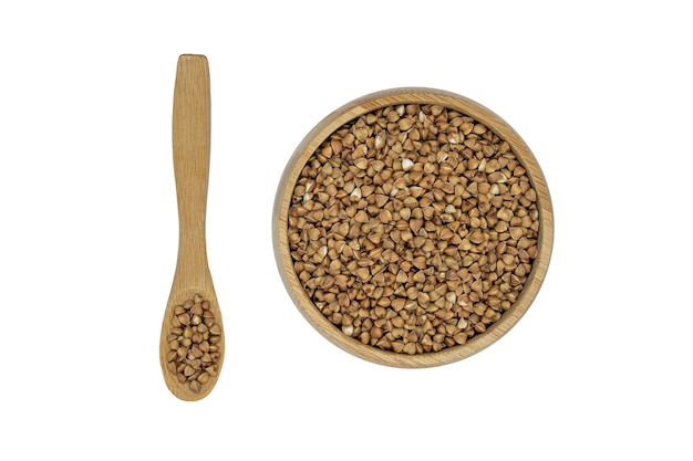 Buckwheat groats in a bowl and wooden spoon isolated on white background