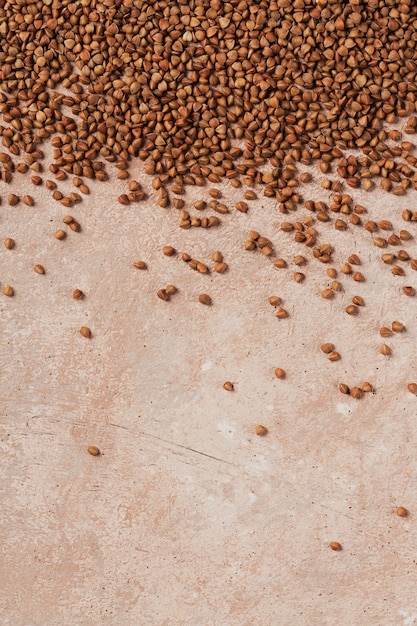 Buckwheat groats close up. Grains of raw buckwheat as a abstract background texture.