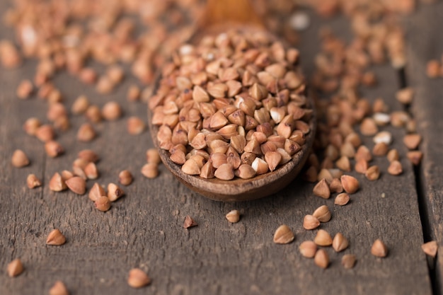 Buckwheat groats on wooden background